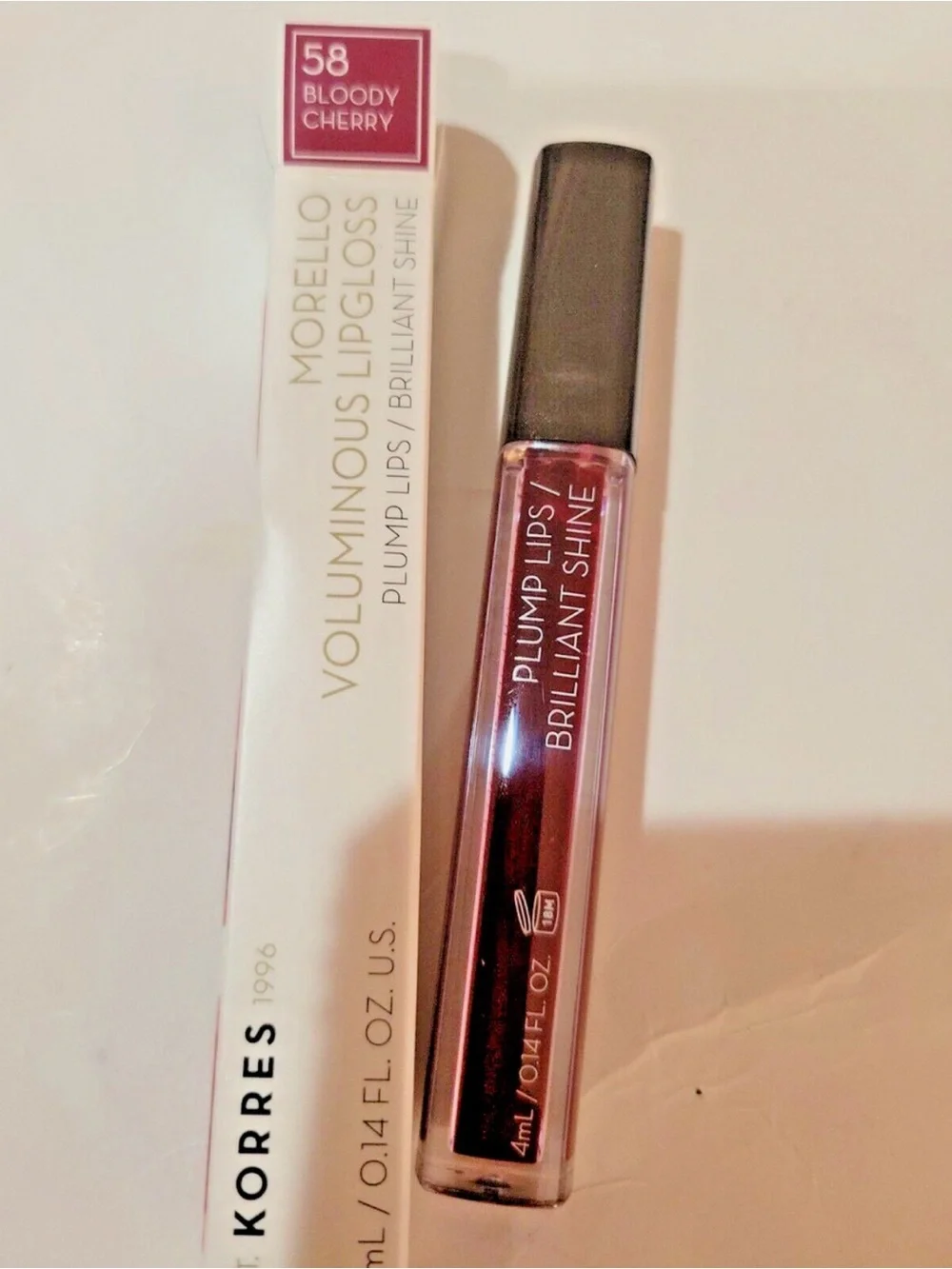 BOODY Lip Gloss - Shiny White Packaging with Red Nails Visible